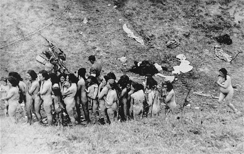 Naked Jewish women, some of whom are holding infants, wait in a line before their execution by Ukrainian auxilliary police